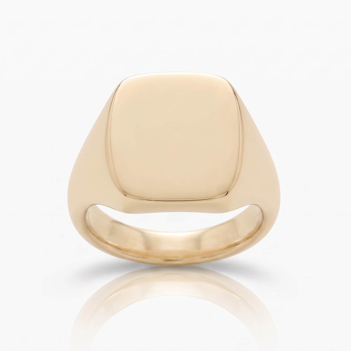 A polished yellow gold signet ring with a square-shaped face, shown on a clean white background with a soft reflection below.

