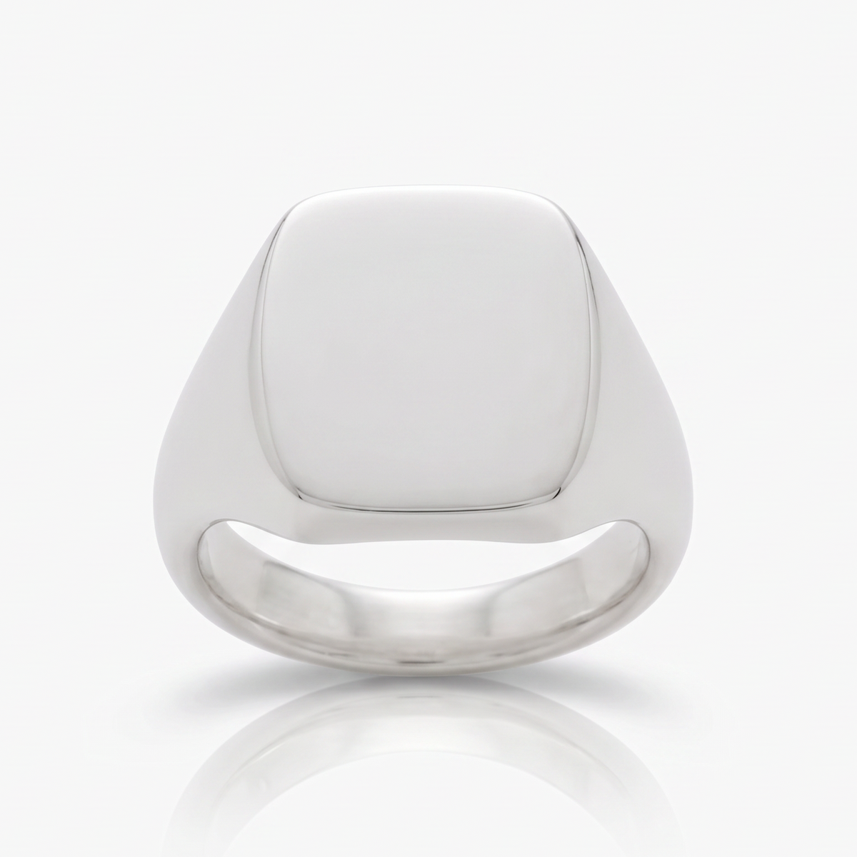 A polished silver signet ring with a smooth, rounded square face, shown on a clean white background with a soft reflection below.

